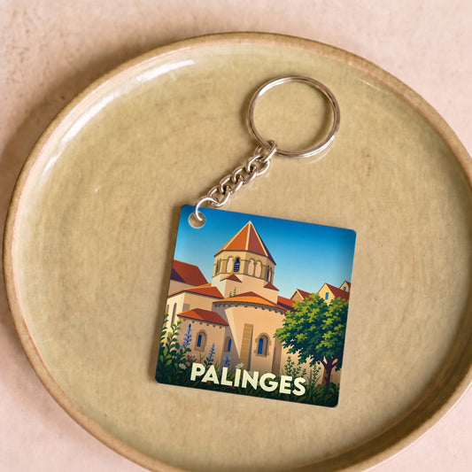 Porte-clés souvenir de la ville de Palinges avec une illustration stylisée d'un édifice historique.