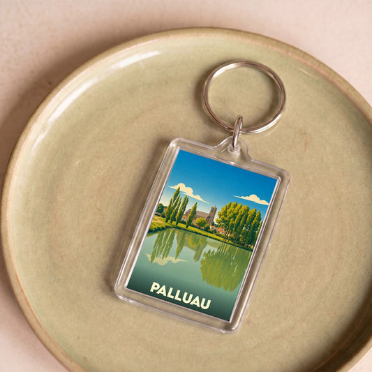 Porte-clés souvenir de la ville de Palluau avec une illustration stylisée d'un paysage aquatique.