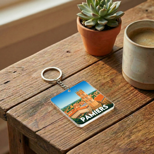 Porte-clés souvenir de la ville de Pamiers avec une illustration stylisée.