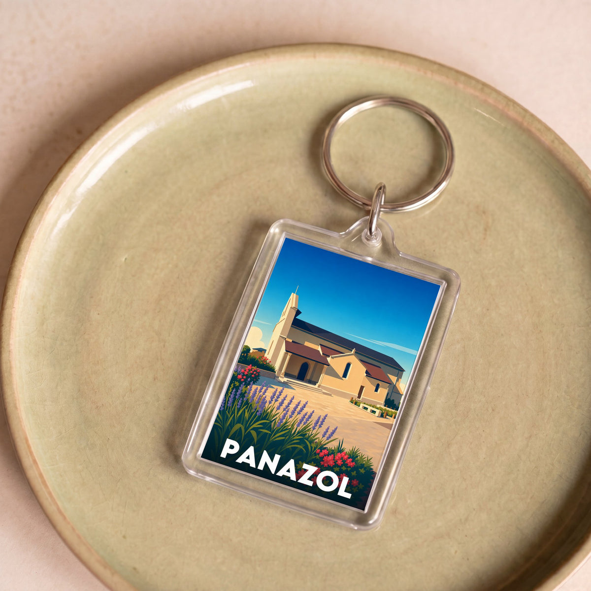 Porte-clés souvenir de la ville de Panazol avec une illustration stylisée.
