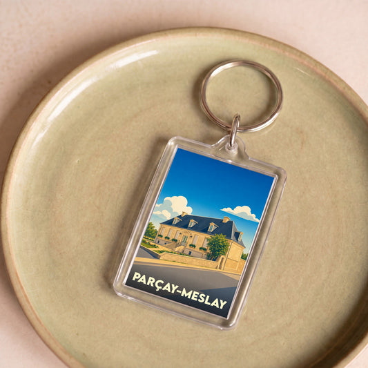 Porte-clés souvenir de la ville de Parçay-Meslay avec une illustration stylisée.