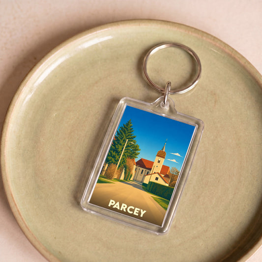 Porte-clés souvenir de la ville de Parcey avec une illustration stylisée d'une église et son clocher.