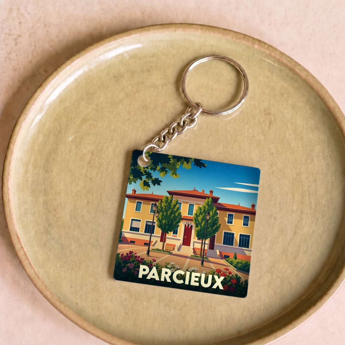 Porte-clés souvenir de la ville de Parcieux avec une illustration stylisée.