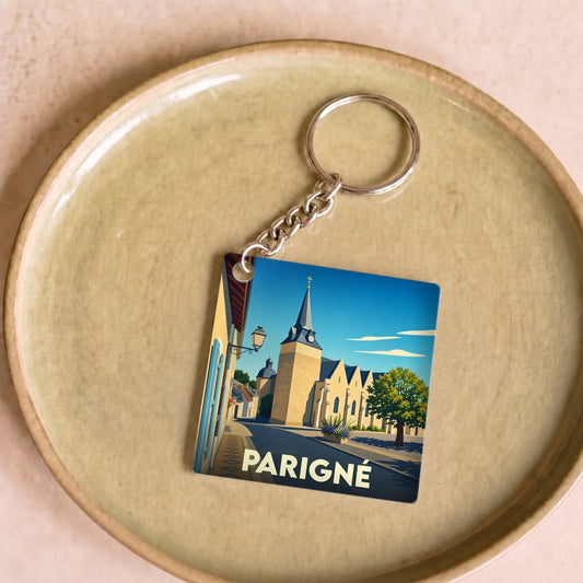 Porte-clés souvenir de la ville de Parigné avec une illustration stylisée.