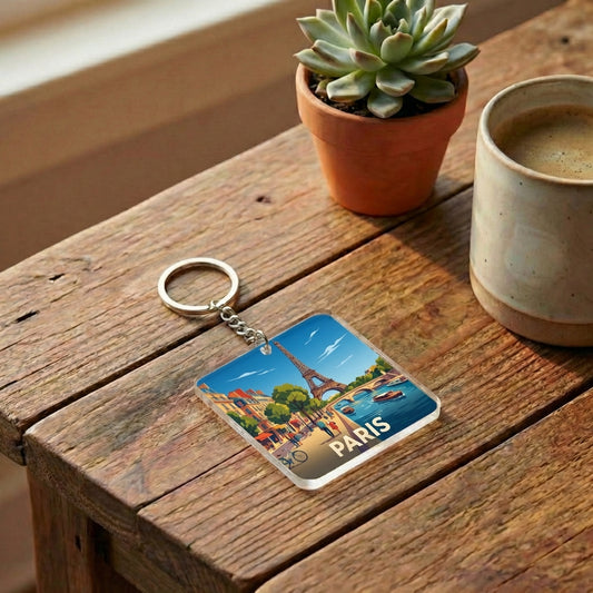 Porte-clés souvenir de la ville de Paris avec une illustration stylisée et colorée de la tour Eiffel.