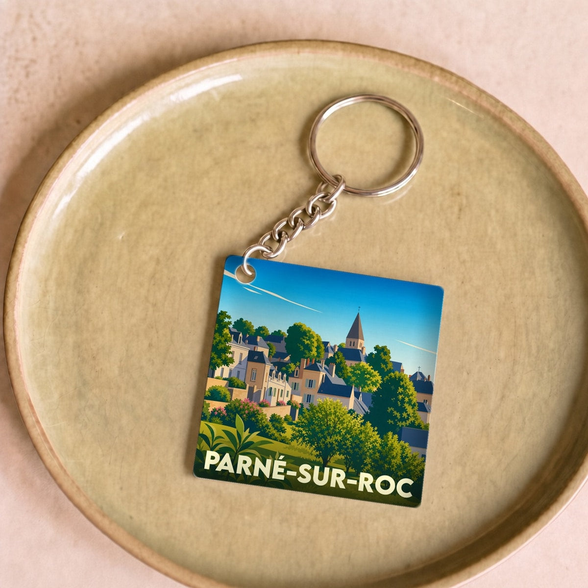 Porte-clés souvenir de la ville de Parné-sur-Roc avec une illustration stylisée.