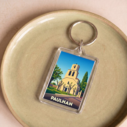 Porte-clés souvenir de la ville de Paulhan avec une illustration stylisée de son église.
