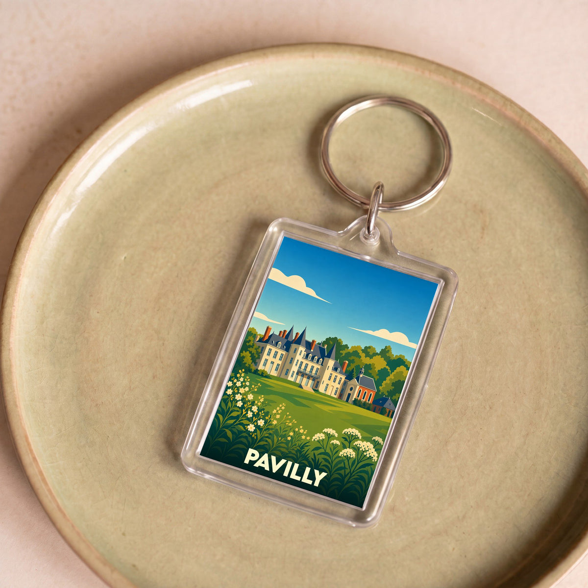Porte-clés souvenir de la ville de Pavilly avec une illustration stylisée de son château.