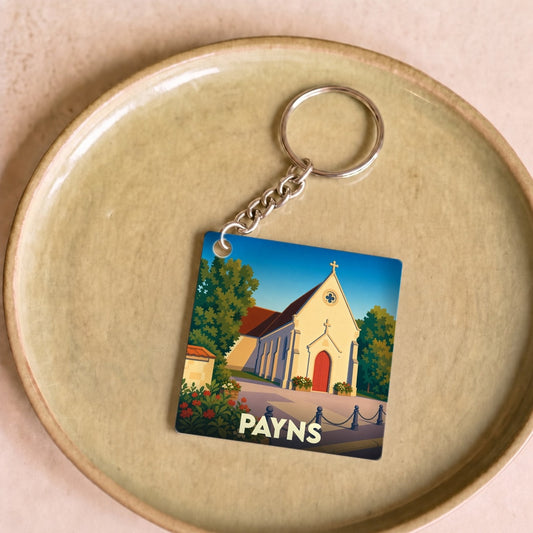 Porte-clés souvenir de la ville de Payns avec une illustration stylisée d'une église locale.