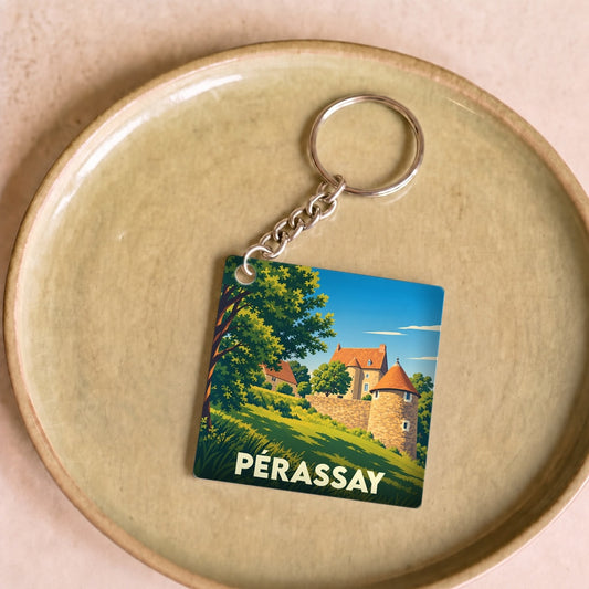 Porte-clés souvenir de la ville de Pérassay avec une illustration stylisée d'un château.