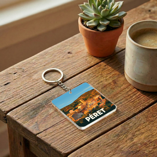 Porte-clés souvenir de la ville de Péret avec une illustration stylisée.