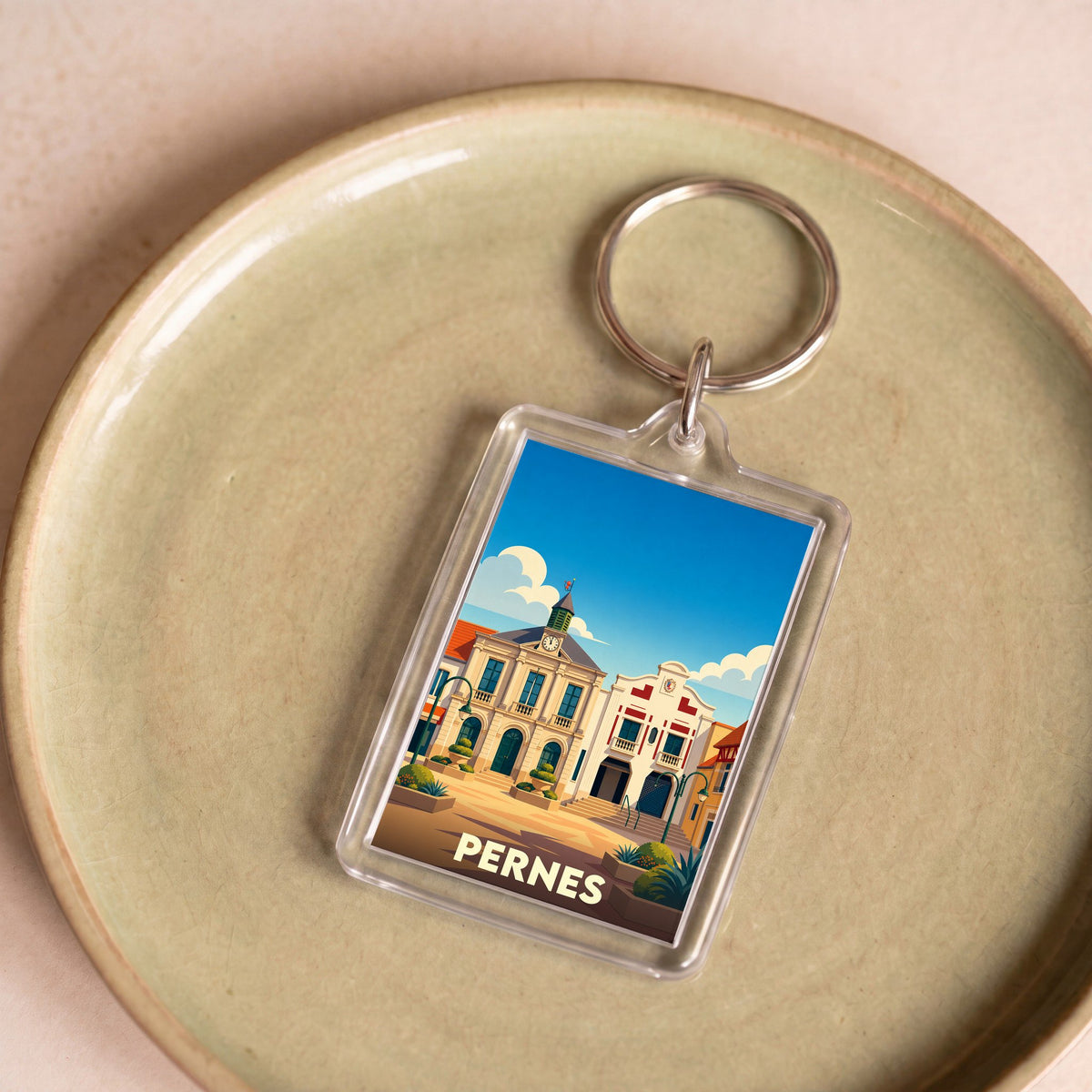 Porte-clés souvenir de la ville de Pernes avec une illustration stylisée.