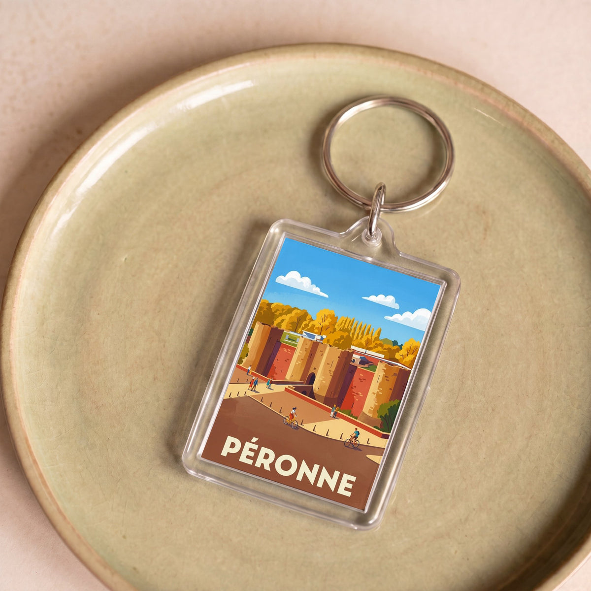 Porte-clés souvenir de la ville de Péronne avec une illustration stylisée.
