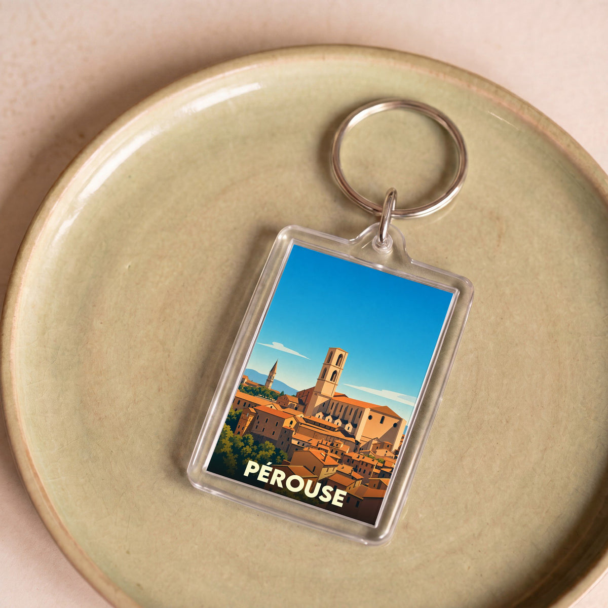 Porte-clés souvenir de la ville de Pérouse avec une illustration stylisée.