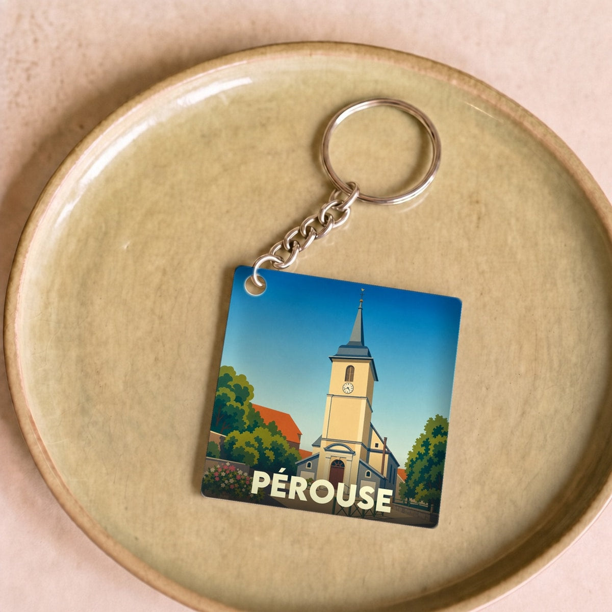 Porte-clés souvenir de la ville de Pérouse avec une illustration stylisée.