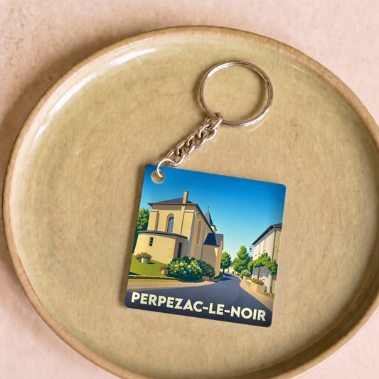 Porte-clés souvenir de la ville de Perpezac-le-Noir avec une illustration stylisée.