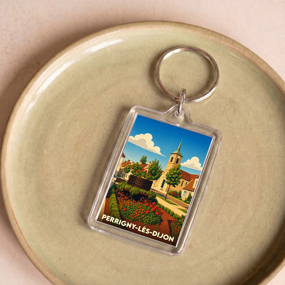 Porte-clés souvenir de la ville de Perrigny-lès-Dijon avec une illustration stylisée et colorée.