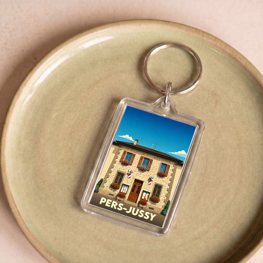 Porte-clés souvenir de la ville de Pers-Jussy avec une illustration stylisée de sa mairie.