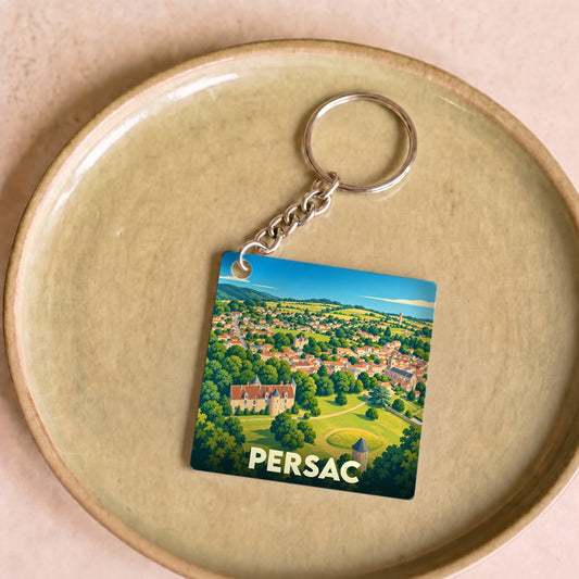 Porte-clés souvenir de la ville de Persac avec une illustration paysagère colorée.