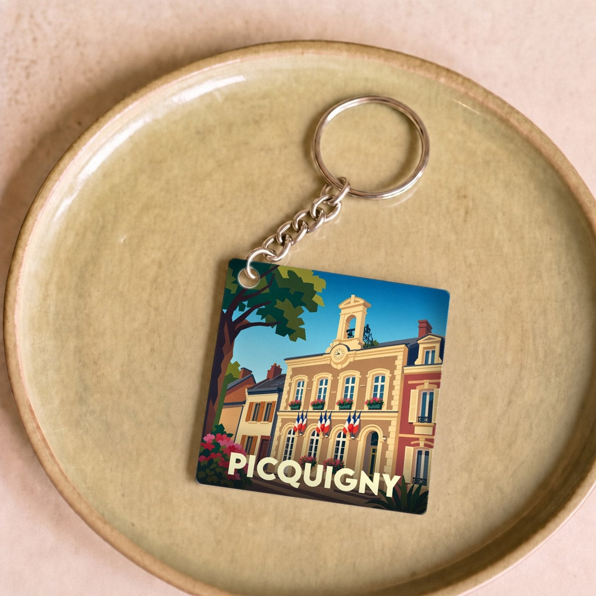 Porte-clés souvenir de la ville de Picquigny avec une illustration stylisée de l'hôtel de ville.