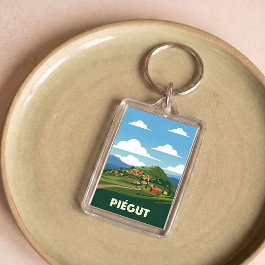 Porte-clés souvenir de la ville de Piégut orné d'une illustration stylisée.