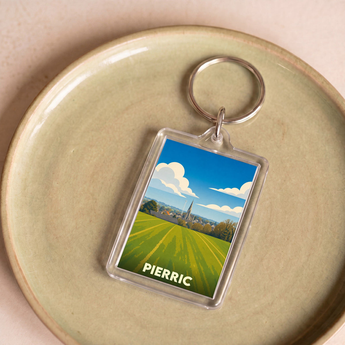 Porte-clés souvenir de la ville de Pierric avec une illustration stylisée de son paysage et de son église.