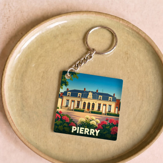 Porte-clés souvenir de la ville de Pierry avec une illustration stylisée d'un château fleuri.