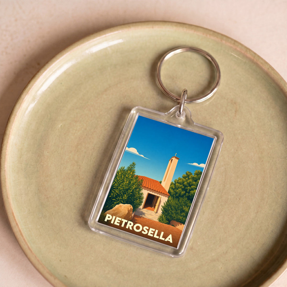 Porte-clés souvenir de la ville de Pietrosella avec une illustration stylisée.