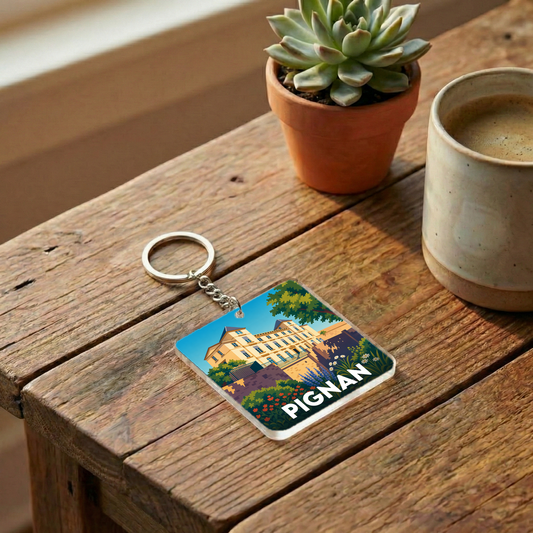 Porte-clés souvenir de la ville de Pignan avec une illustration stylisée.