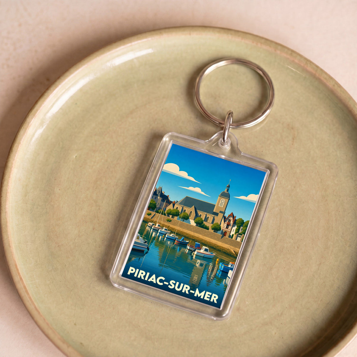 Porte-clés souvenir de la ville de Piriac-sur-Mer avec une illustration stylisée.