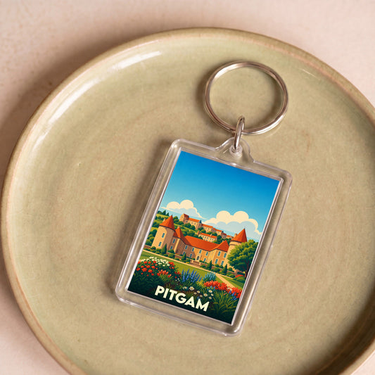 Porte-clés souvenir de la ville de Pitgam avec une illustration stylisée.