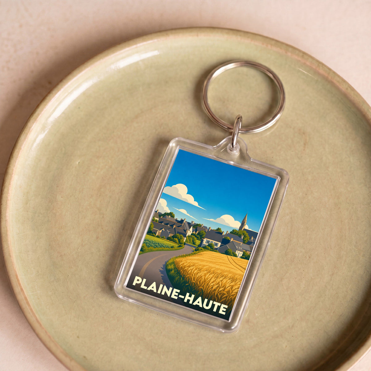 Porte-clés souvenir de la ville de Plaine-Haute avec une illustration stylisée.