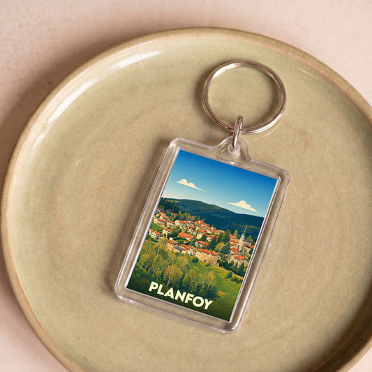 Porte-clés souvenir de la ville de Planfoy avec une illustration stylisée.
