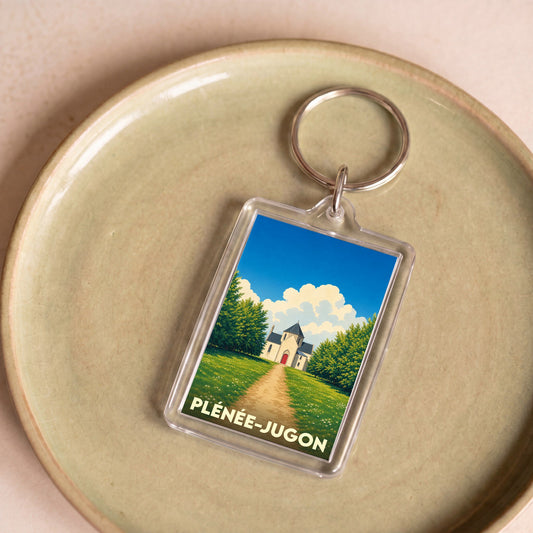 Porte-clés souvenir de la ville de Plénée-Jugon avec une illustration stylisée.