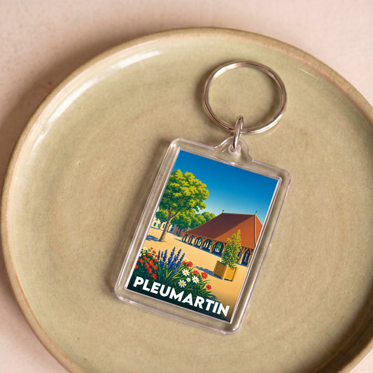 Porte-clés souvenir de la ville de Pleumartin avec une illustration stylisée.