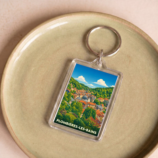 Porte-clés souvenir de la ville de Plombières-les-Bains avec une illustration stylisée.