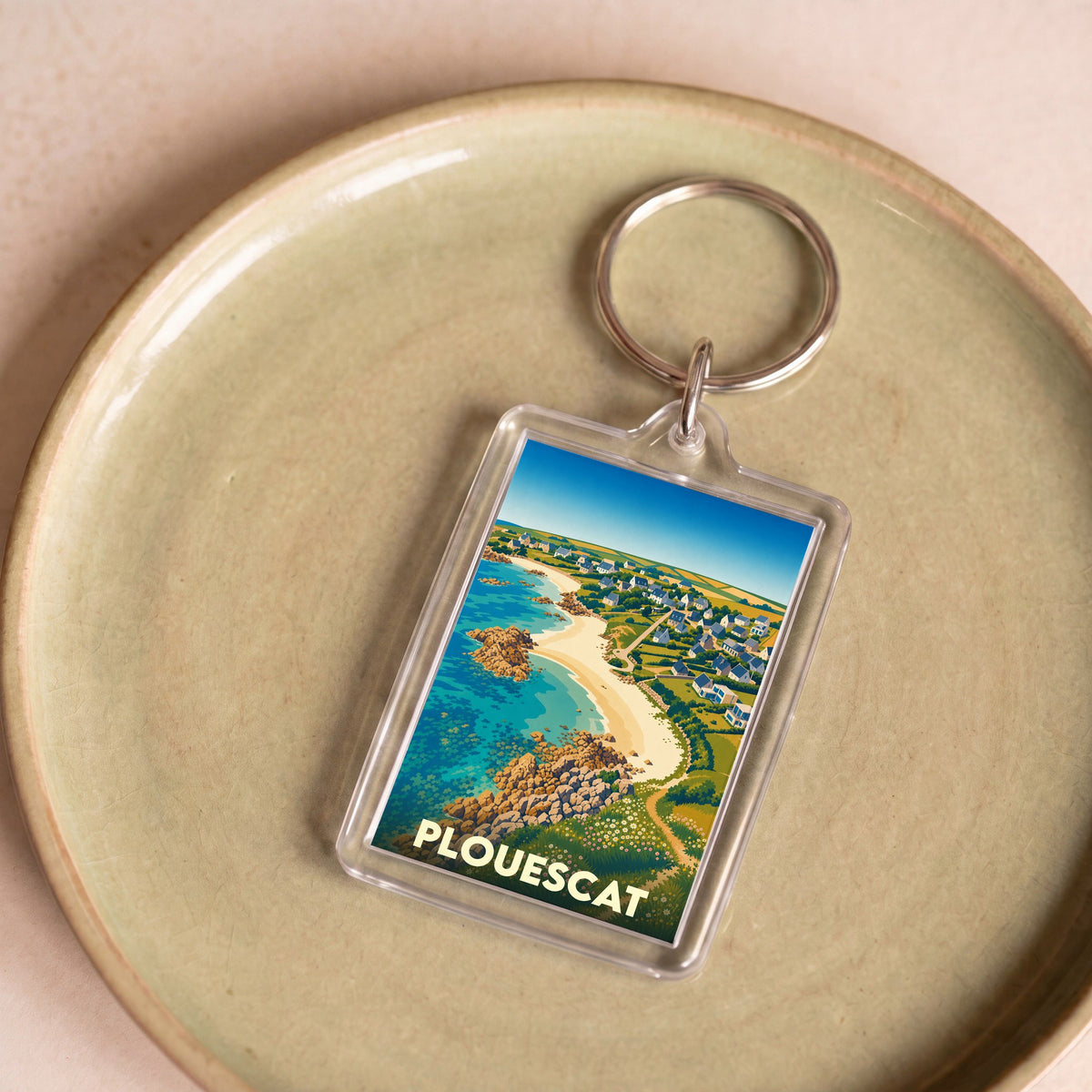Porte-clés souvenir de la ville de Plouescat avec une illustration stylisée de sa côte littorale.