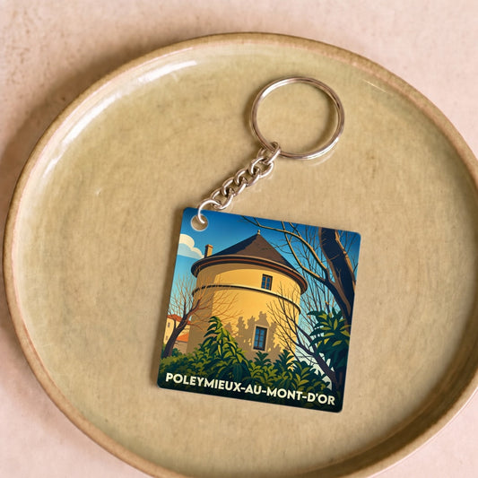 Porte-clés souvenir de la ville de Poleymieux-au-Mont-d'Or avec une illustration stylisée d'une tour médiévale.