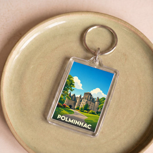 Porte-clés souvenir de la ville de Polminhac avec une illustration stylisée de son château.