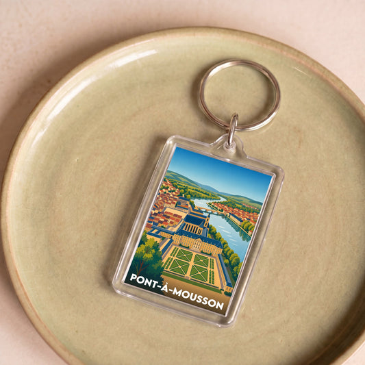 Porte-clés souvenir de la ville de Pont-à-Mousson avec une illustration stylisée et colorée.