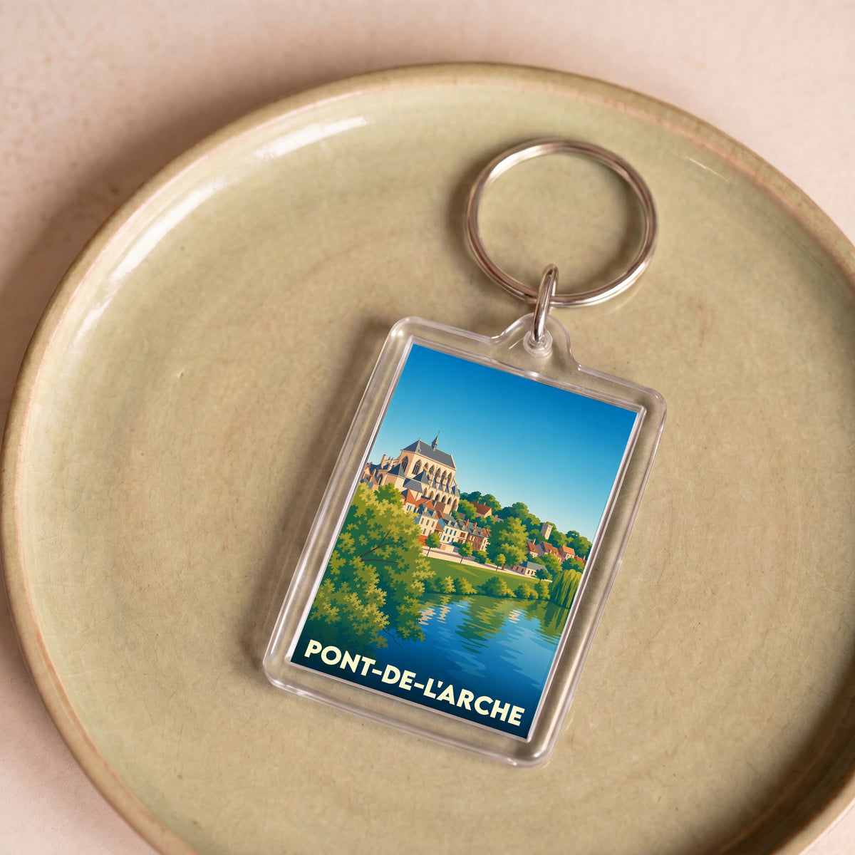 Porte-clés souvenir de la ville de Pont-de-l'Arche avec une illustration stylisée.