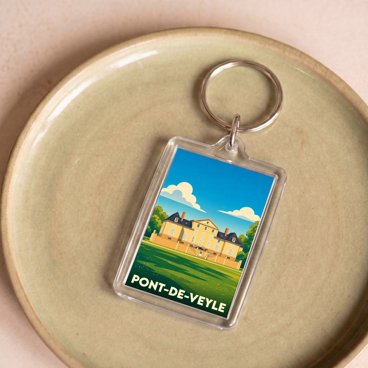 Porte-clés souvenir de la ville de Pont-de-Veyle avec une illustration stylisée de son château.