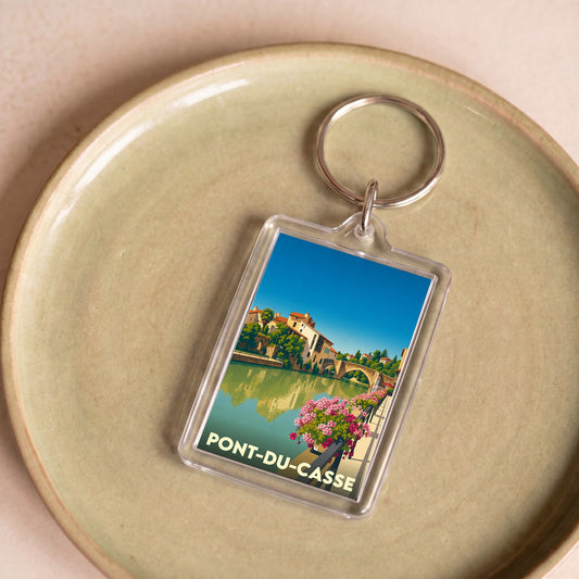Porte-clés souvenir de la ville de Pont-du-Casse avec une illustration stylisée.