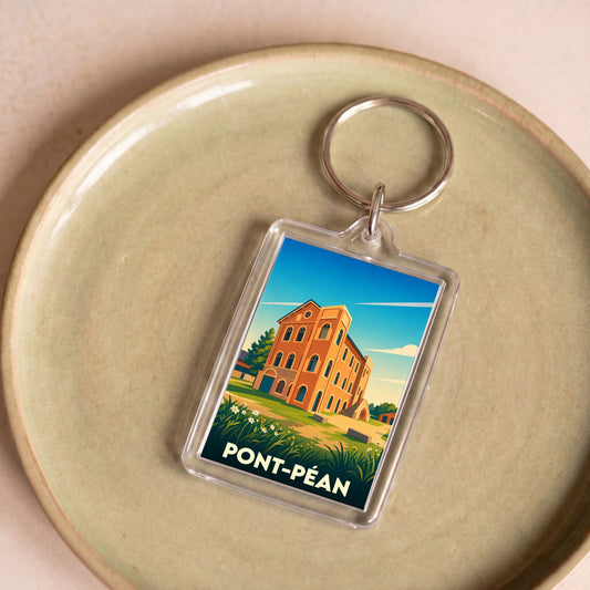 Porte-clés souvenir de la ville de Pont-Péan avec une illustration stylisée de son patrimoine architectural.