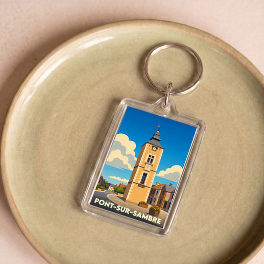 Porte-clés souvenir de la ville de Pont-sur-Sambre avec une illustration stylisée de sa tour penchée.