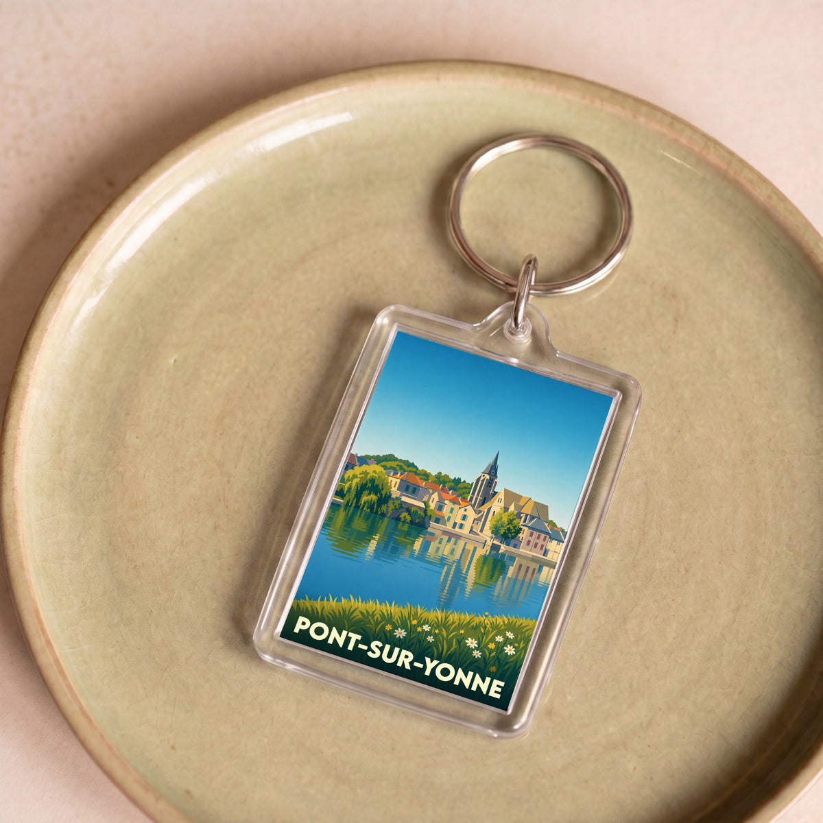 Porte-clés souvenir de la ville de Pont-sur-Yonne avec une illustration stylisée des bords de l'Yonne.