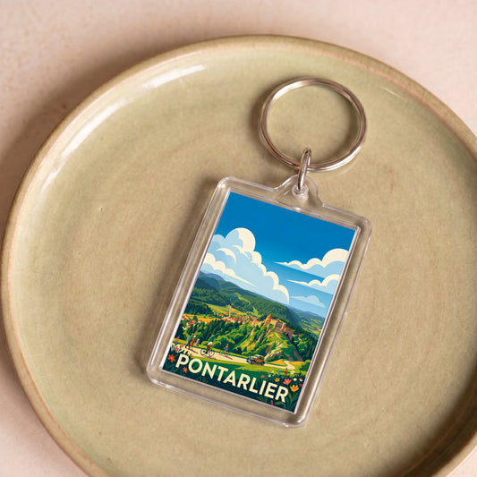 Porte-clés souvenir de la ville de Pontarlier avec une illustration de paysage stylisée.