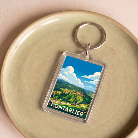 Porte-clés souvenir de la ville de Pontarlier avec une illustration de paysage stylisée.
