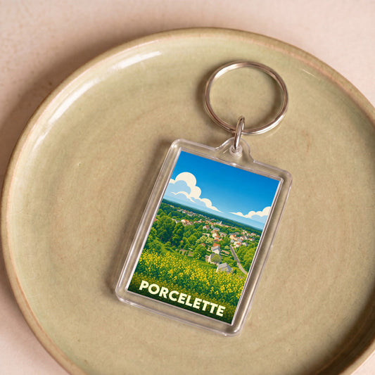 Porte-clés souvenir de la ville de Porcelette avec une illustration stylisée et colorée.