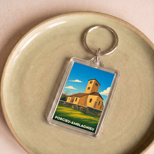 Porte-clés souvenir de la ville de Porcieu-Amblagnieu avec une illustration stylisée de son église.